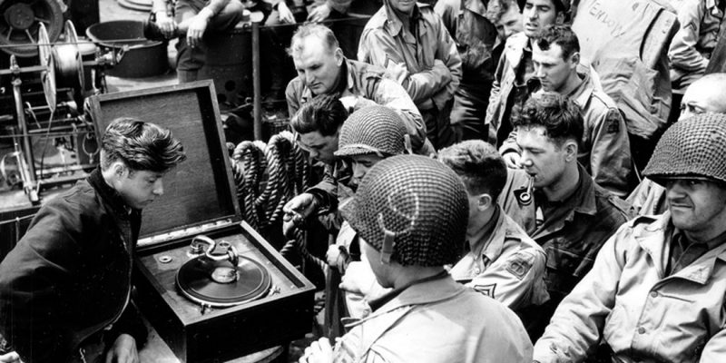 Soldiers listen to music on their way from England to Normandy, 1944 NARA (National Archives and Records Administration), Photographs and Graphic Works, College Park, MD, 26-G-2401