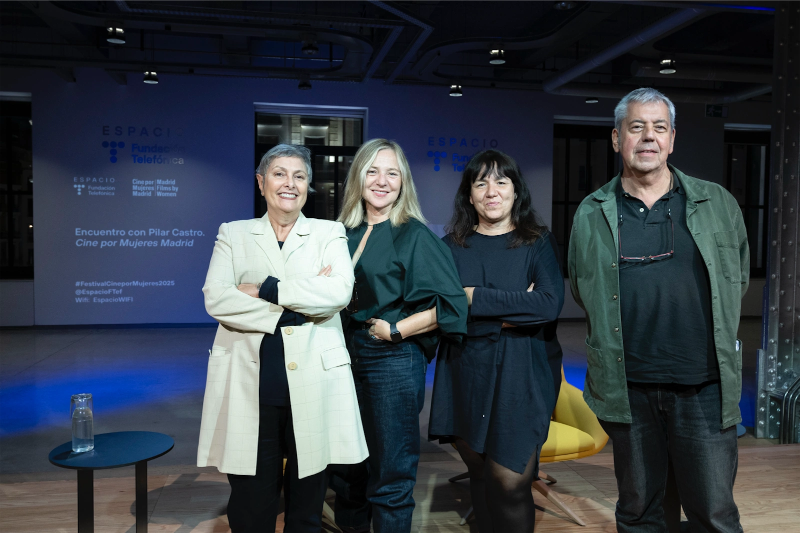 Pilar Castro y María Adell posando juntas en un evento, sonriendo mientras están de pie en foto de familia
